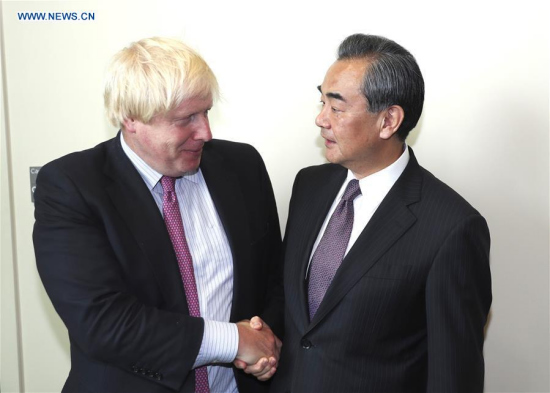 Chinese Foreign Minister Wang Yi (R) shakes hands with his British counterpart Boris Johnson during their meeting at the UN headquarters in New York, on Sept. 19, 2017. (Xinhua/Wang Ying)