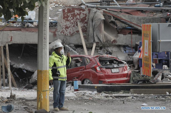 A rescuer works in front of a collapsed building in Mexico City, Capital of Mexico, on Sept. 20, 2017. (Xinhua/Dan Hang)