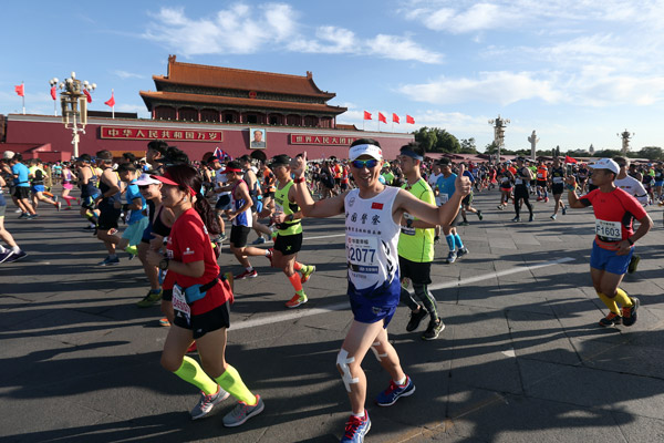 Runners get moving in the 2017 Beijing Marathon at Tian'anmen Square on Sept 17. Li Nan / For China Daily