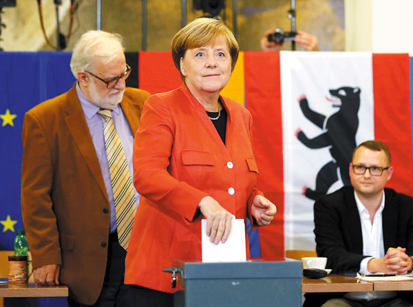 German Chancellor and leader of the Christian Democratic Union Angela Merkel votes in the general election in Berlin, Germany, on Sunday. FABRIZIO BENSCH / REUTERS