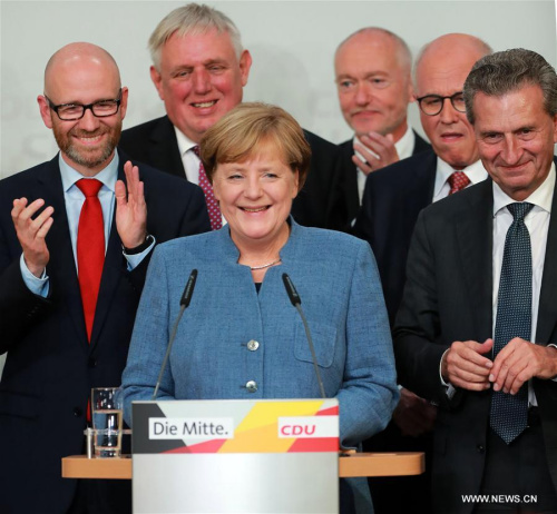 German sitting Chancellor Angela Merkel (Front) is applauded after the preliminary exit poll at the Christian Democratic Union (CDU) party's headquarters in Berlin, Germany, on Sept. 24, 2017. (Xinhua/Luo Huanhuan)
