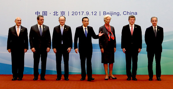 Premier Li Keqiang hosts international financial leaders on Tuesday in Beijing. They are, from left: Angel Gurria of the Organization for Economic Cooperation and Development, Roberto Azevedo of the World Trade Organization, Jim Yong Kim of the World Bank Group, Christine Lagarde of the International Monetary Fund, Guy Ryder of the International Labour Organization and Mark Carney of the G20 Financial Stability Board. (Photo by WU ZHIYI/CHINA DAILY)