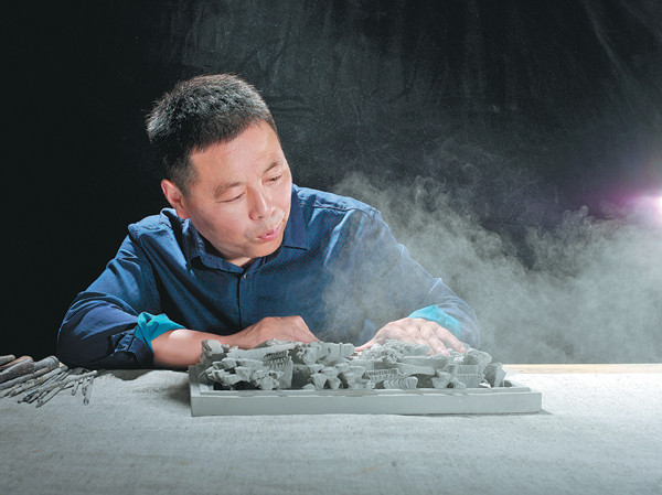 Wu Zhenghui has dedicated himself to the art of brick carving for 28 years. (Photo provided to China Daily)