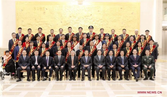 Chinese Vice Premier Wang Yang (6th R, front) poses for a group photo with poverty relief role models before a meeting honoring people who have made great contributions to poverty relief, in Beijing, capital of China, Oct. 9, 2017. (Xinhua/Ding Lin)