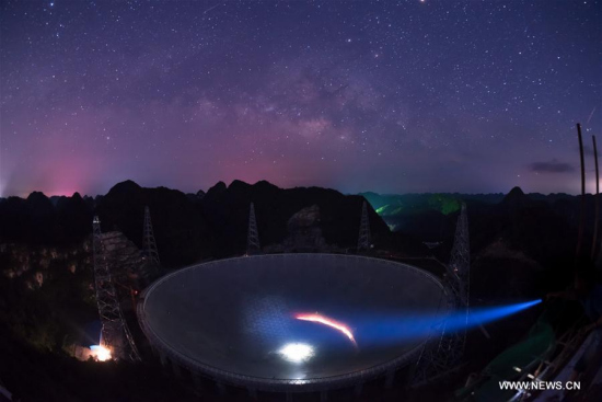 Photo taken on June 27, 2016 shows the Five-hundred-meter Aperture Spherical Telescope (FAST) under the stars in Pingtang County, southwest China's Guizhou Province. The China-based FAST, the world's largest single-dish radio telescope, has identified two pulsars after one year of trial operation, the National Astronomical Observatories of China (NAOC) said on Oct. 10, 2017. (Xinhua/Liu Xu)
