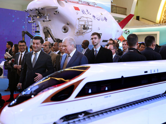 A group of foreign diplomats and foreign experts working in China visit an exhibition in Beijing on Friday showcasing China's achievements over the past five years. ZOU HONG/CHINA DAILY