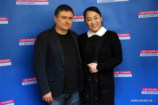 Romanian director Cristian Mungiu (L), three times winner of Cannes prizes and president of the 2017 Shanghai International Film Festival, poses for a photograph with Sun Peng, Chairwoman and CEO of Zhejiang Roc Picture and the producer of The Chinese Widow, during the 8th edition of the film festival entitled Les Films de Cannes a Bucharest (Cannes Film Festival in Bucharest) at a cinema in Bucharest, capital of Romania, on Oct. 14, 2017. 