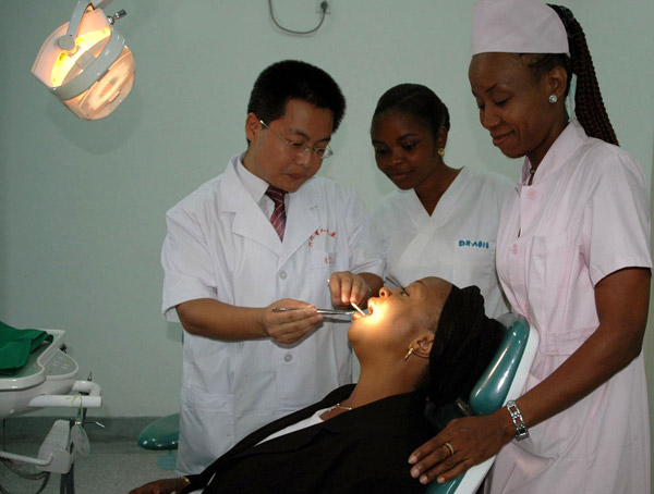Chinese dentist Zhang Qingbin examines a local resident at the sino-Congo Friendship Hospital in Brazzaville. (Photo by Wang Zhao/Xinhua)