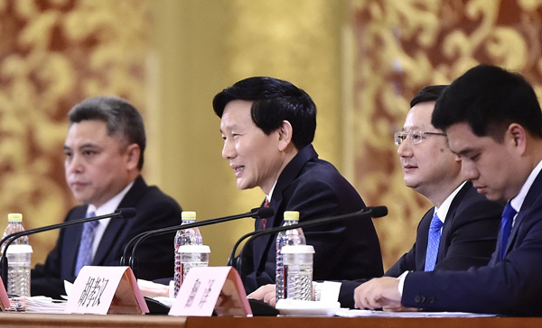 Spokesman for the 19th National Congress of the Communist Party of China Tuo Zhen (center) answers questions from journalists at a news conference at the Great Hall of the People on Tuesday in Beijing. (Photo/Xinhua)