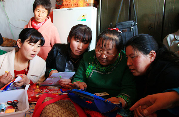 Women take part in an embroidery class in the Inner Mongolia autonomous region's Horqin Right Wing Middle Banner to learn how to decorate clothes, slippers and pillowcases with traditional designs. (Photo provided to China Daily)