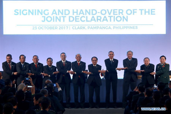 Participants join their hands during the signing and hand-over of the joint declaration on the ASEAN Defense Ministers' Meeting (ADMM) in Clark, the Philippines, Oct. 23, 2017. (Xinhua/Rouelle Umali)