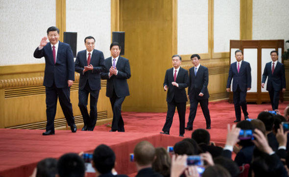 Xi Jinping, general secretary of the Central Committee of the Communist Party of China, and the other newly elected members of the Standing Committee of the Political Bureau of the 19th CPC Central Committee Li Keqiang, Li Zhanshu, Wang Yang, Wang Huning, Zhao Leji and Han Zheng arrive to meet the press at the Great Hall of the People in Beijing on Wednesday. (XU JINGXING / CHINA DAILY)