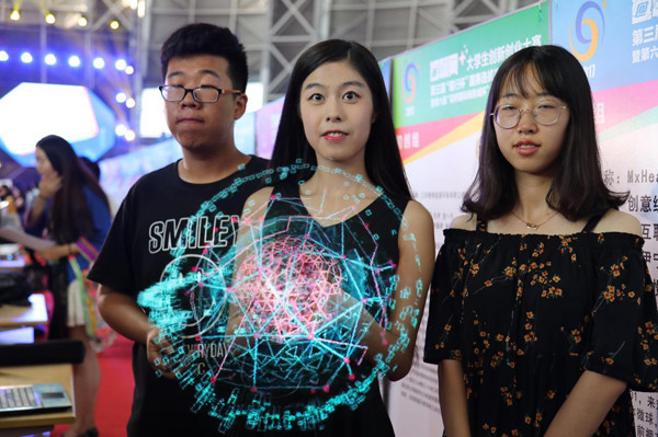DSeeLab employees show the 'fan' that creates 3D images during an innovation competition in Nanjing, Jiangsu province, in July. (Photo by LIU LI/CHINA DAILY)
