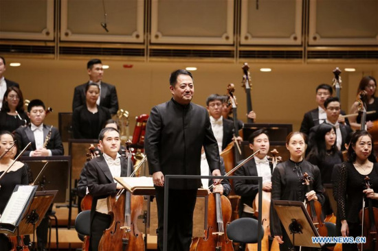 Lu Jia, music director and chief conductor of the Performing Arts (NCPA) Orchestra greets the audience at the Symphony Center in Chicago, the United States, Oct. 28, 2017. A sold-out concert performed here Saturday by China NCPA Orchestra caught the attention of the whole audience by showcasing a unique combination of Western and Chinese music.(Xinhua/Wang Ping)