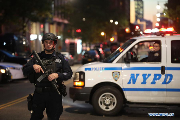 Police officers stand guard near the site of an attack in lower Manhattan in New York, the United States, on Oct. 31, 2017. Eight people were killed and a dozen more injured after a truck plowed into pedestrians near the World Trade Center in New York City, the mayor said on Tuesday. (Xinhua/Wang Ying)