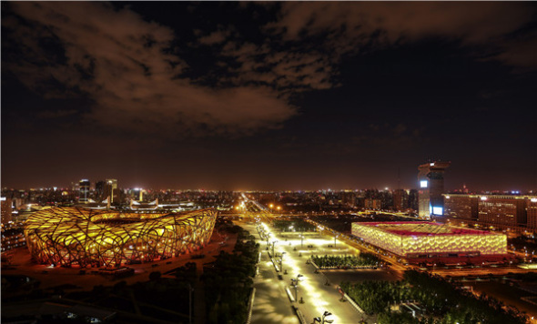 A night shot of the Beijing National Stadium, or the Bird's Nest, and Beijing National Aquatics Center, or Water Cube. (Photo/Xinhua)