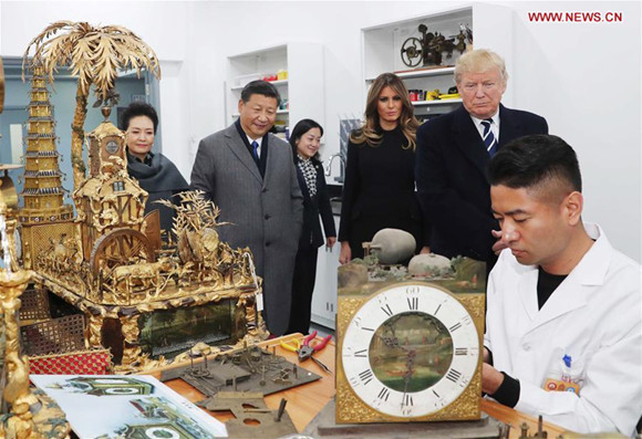 Chinese President Xi Jinping (2nd L) and his wife Peng Liyuan (1st L), and U.S. President Donald Trump (2nd R) and his wife Melania Trump (3rd R) watch the repair of some historical relics at the conservation workshop of the Palace Museum in Beijing, capital of China, Nov. 8, 2017. (Xinhua/Liu Weibing)