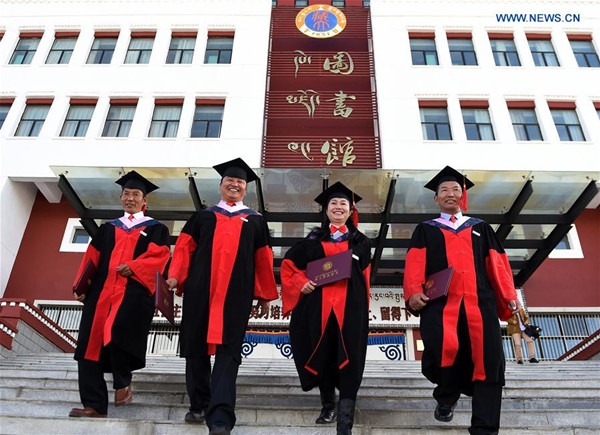 Four PhD graduates are seen after a graduation ceremony at Tibet University in Lhasa, southwest China's Tibet Autonomous Region, Nov. 10, 2017. Four PhD candidates researching Tibetan history, language or medicine became the first group of holders of doctorates awarded by a Tibetan university. (Xinhua/Chogo)