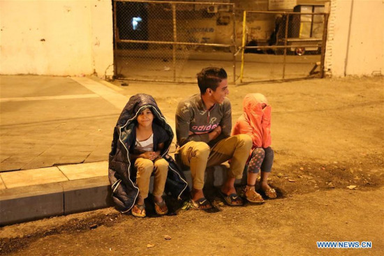 People gather outdoor in Baghdad, Iraq, on Nov. 12, 2017. A huge earthquake measuring 7.2 magnitude hit Iraq's northern province of Sulaimaniyah on Sunday, killing four people and injuring 50 others, according to the Kurdish Rudaw newsite. (Xinhua/Khalil Dawood)