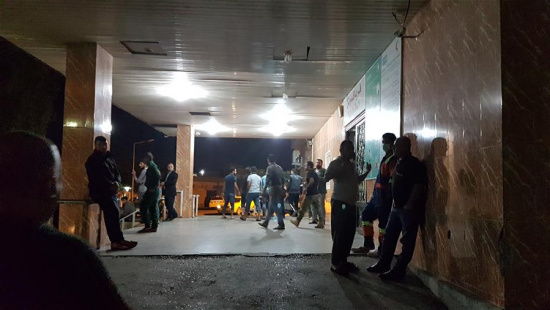 People stand outside a hospital where injured people receive medical treatment in Kirkuk, Iraq, on Nov. 12, 2017. (Xinhua/Raizer Zangana)