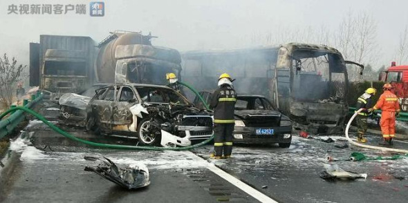 Firefighters put out a fire caused by a pile-up of more than 30 vehicles on an expressway in east China's Anhui Province, Nov. 15, 2017. (Photo/CCTV)