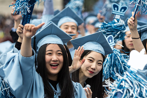 Several Chinese students cheer at Colombia University graduation ceremonies last year in New York City. [Photo/Xinhua]