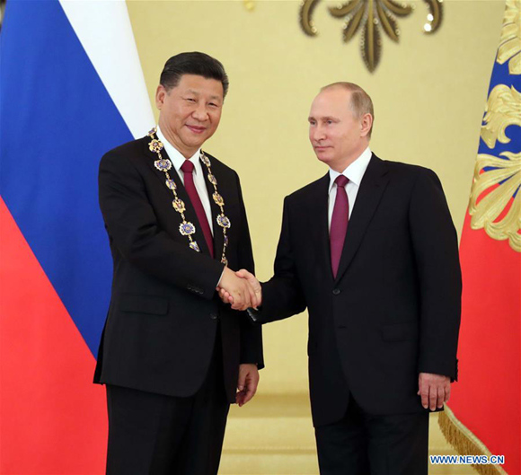 Xi Jinping is awarded by his Russian counterpart Vladimir Putin the highest order of Russia, or the Order of St. Andrew the Apostle the First-Called, after their talks in Moscow, Russia, July 4, 2017. (Xinhua/Liu Weibing)