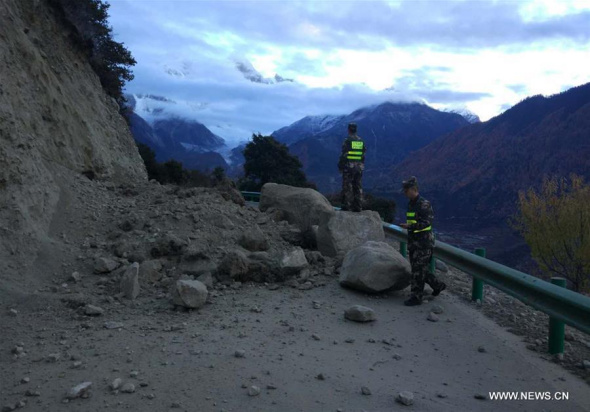 Photo taken with a mobile phone shows rescuers checking a blocked road in Paizhen Town of Mainling County under Nyingchi City, southwest China's Tibet Autonomous Region, Nov. 18, 2017. A 6.9-magnitude earthquake hit Nyingchi Saturday morning. (Xinhua/Liu Pengchao)