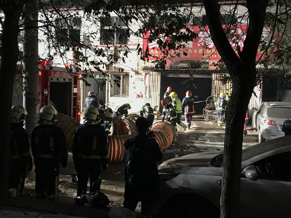 Firefighters work at the site of a fire in Daxing District of Beijing, capital of China, November 19, 2017. Nineteen people were killed and eight others injured according to local authorities. (Xinhua/Luo Xiaoguang)