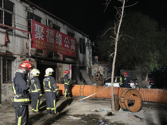 Firefighters work at the site of a fire in Daxing District of Beijing, capital of China, November 19, 2017. Nineteen people were killed and eight others injured according to local authorities. (Xinhua/Luo Xiaoguang)