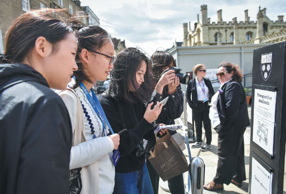 Chinese students on a study tour to the United Kingdom gather at the gate of King's College, Cambridge University.Tan Xi / For China Daily