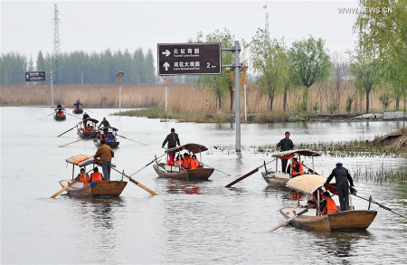 Photo taken on April 9, 2017 shows tourists taking boat in Baiyangdian, one of the largest freshwater wetlands in north China, in Anxin County, north China's Hebei Province. China announced the plan for Xiongan New Area officially on April 1, 2017. (Xinhua/Yang Shiyao)