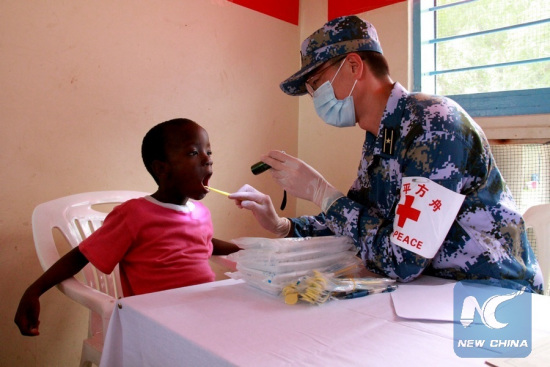 A doctor from the Chinese naval hospital ship Peace Ark examines a child at the Kurasini Children's Home in Dar es Salaam, Tanzania, Nov. 21, 2017. (Xinhua/Li Sibo)