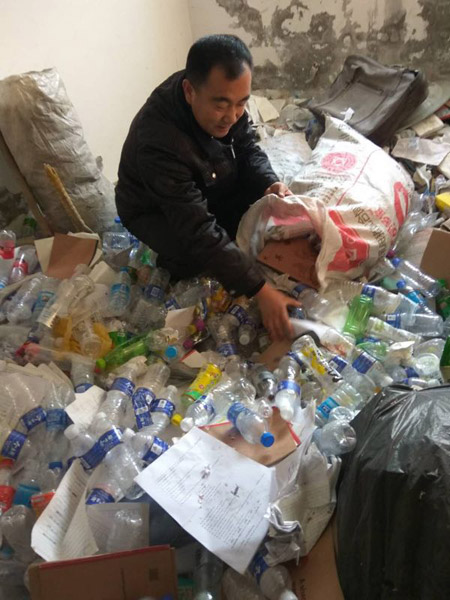 He Chunyu, a middle school teacher, puts the discarded plastic bottles into a bag. (Photo provided to China Daily)