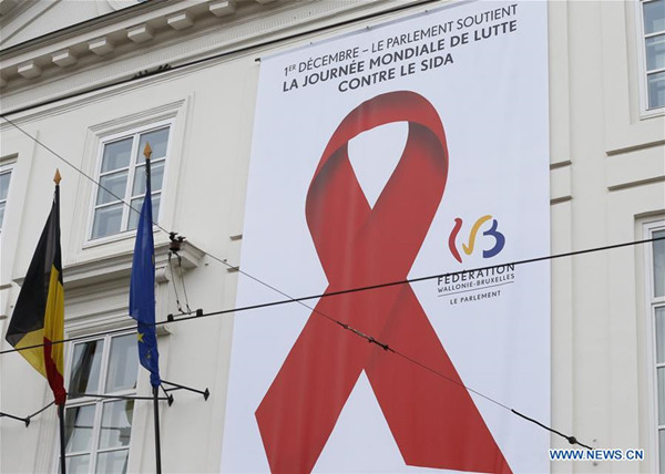 Photo taken on Dec. 1, 2017 shows a poster with red ribbon logo on the exterior wall of a government building in downtown Brussels, Belgium, on the occasion of World Aids Day. (Xinhua/Ye Pingfan)