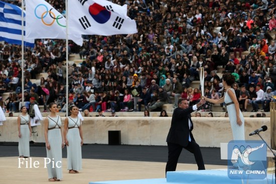 Greek actress Katerina Lehou (1st R) in the role of an Ancient Greek High Priestess passes the Sacred Olympic Flame to Hellenic Olympic Committee President Spyros Capralos at Panathenaic stadium in Athens on Oct. 31, 2017,during the handover ceremony of the Olympic flame for the 2018 Winter Olympics in Pyeongchang, South Korea.(Xinhua/Marios Lolos)