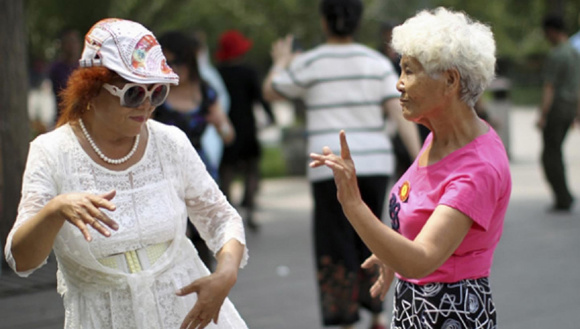 Public square dancing helps grannies develop a social network to counter loneliness in old age and it also keeps them physically and mentally fit. (Photo/China Daily)