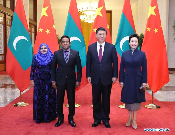 Chinese President Xi Jinping (2nd R) and his wife Peng Liyuan (1st R) pose for group photos with Maldives President Abdulla Yameen Abdul Gayoom (2nd L) and his wife at the Great Hall of the People in Beijing, capital of China, Dec. 7, 2017. Xi held talks with Yameen in Beijing on Thursday. (Xinhua/Ju Peng)