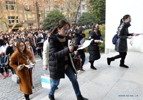 Examinees walk into Nanjing Forestry University to take the National Civil Servant Exam in Nanjing, east China's Jiangsu Province, Dec. 10, 2017. More than 1.1 million people took the National Public Servant Exam in China Sunday, a leap from last year's 984,000, marking the second time the number has hit the one million mark. (Xinhua/Sun Can)