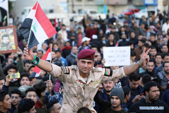 People celebrate the victory of the war against the Islamic State (IS) on Tahrir Square, Baghdad, Iraq, on Dec. 10, 2017. Iraqi Prime Minister Haider al-Abadi on Saturday officially declared full liberation of Iraq from the Islamic State militants after Iraqi forces recaptured all the areas once seized by the extremist group. (Xinhua/Khalil Dawood)
