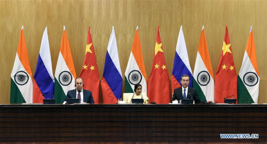 Chinese Foreign Minister Wang Yi (R) addresses a press conference after the 15th trilateral meeting of the foreign ministers of China, Russia and India with his Russian counterpart Sergei Lavrov (L) and Indian counterpart Sushma Swaraj in New Delhi, India, on Dec. 11, 2017. (Xinhua/Zhang Naijie)