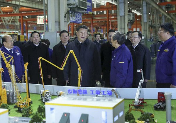 Chinese President Xi Jinping (C, front), also general secretary of the Communist Party of China (CPC) Central Committee and chairman of the Central Military Commission, listens to a brief introduction on the enterprise's participation in the Belt and Road construction when visiting Xuzhou Construction Machinery Group Co., Ltd. in Xuzhou, east China's Jiangsu Province, Dec. 12, 2017. Xi had an inspection tour in Xuzhou on Dec. 12. (Xinhua/Xie Huanchi)