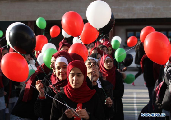 Palestinian students fly balloons as a protest against U.S President Donald Trump's decision to recognize Jerusalem as the capital of Israel, in the West Bank city of Nablus, on Dec. 12, 2017. (Xinhua/Nidal Eshtayeh)