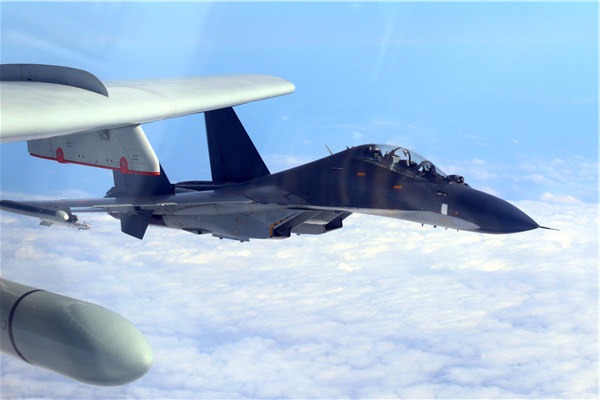 PLA Air Force aircraft conduct a patrol exercise on Monday near Taiwan. The military says such drills are strategically important. (China Daily)