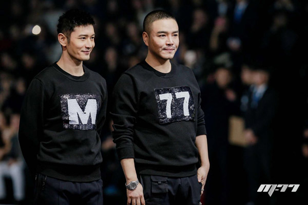Actor Huang Xiaoming (left) and designer Zhang Shuai wear creations of M-77, a new fashion label they launched, at the brand's first fashion show in Beijing. (Photo provided to China Daily)