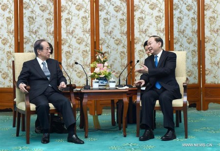 Huang Kunming (R, front), head of the Publicity Department of the Communist Party of China Central Committee, meets with a delegation led by former Japanese Prime Minister Yasuo Fukuda (L, front), who is here to attend the 13th Beijing-Tokyo Forum, in Beijing, capital of China, Dec. 15, 2017. (Xinhua/Zhang Duo)