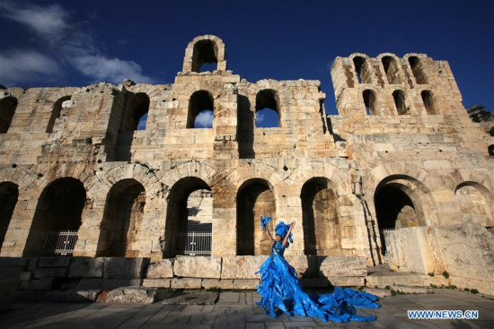 Chinese artist Kong Ning poses for photos during her performance in Athens, Greece, on Dec. 17, 2017. Chinese artist Kong Ning performed at the foot of the Acropolis in the center of Athens on Sunday in a bid to raise public awareness on environmental protection. (Xinhua/Marios Lolos)