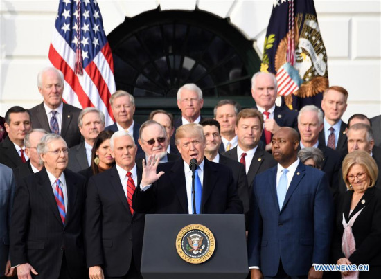 U.S. President Donald Trump (C) speaks at an event celebrating the passage of the tax bill on the South Lawn of the White House in Washington D.C., the United States, on Dec. 20, 2017. (Xinhua/Yin Bogu)