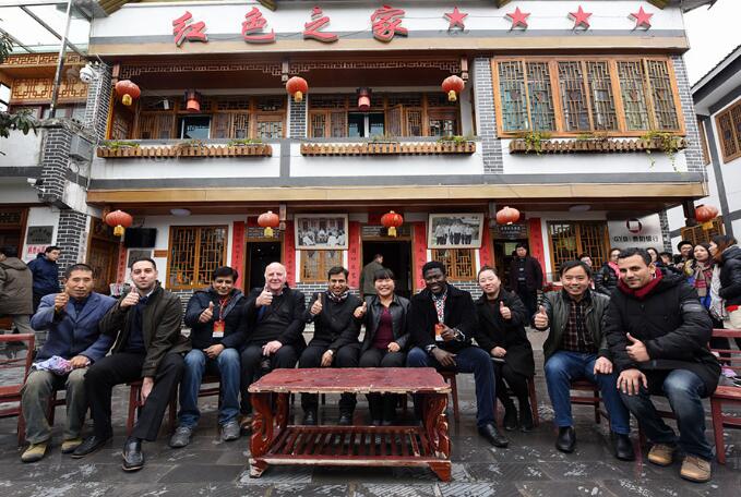 Foreign experts join residents of Huamao village, Guizhou province, to chat about their experiences of poverty alleviation. WU WEI/FOR CHINA DAILY