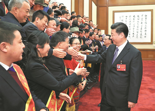 President Xi Jinping greets role models from the country's agricultural sector ahead of the Central Rural Work Conference in Beijing. The two-day gathering concluded on Friday. XIE HUANCHI / XINHUA 